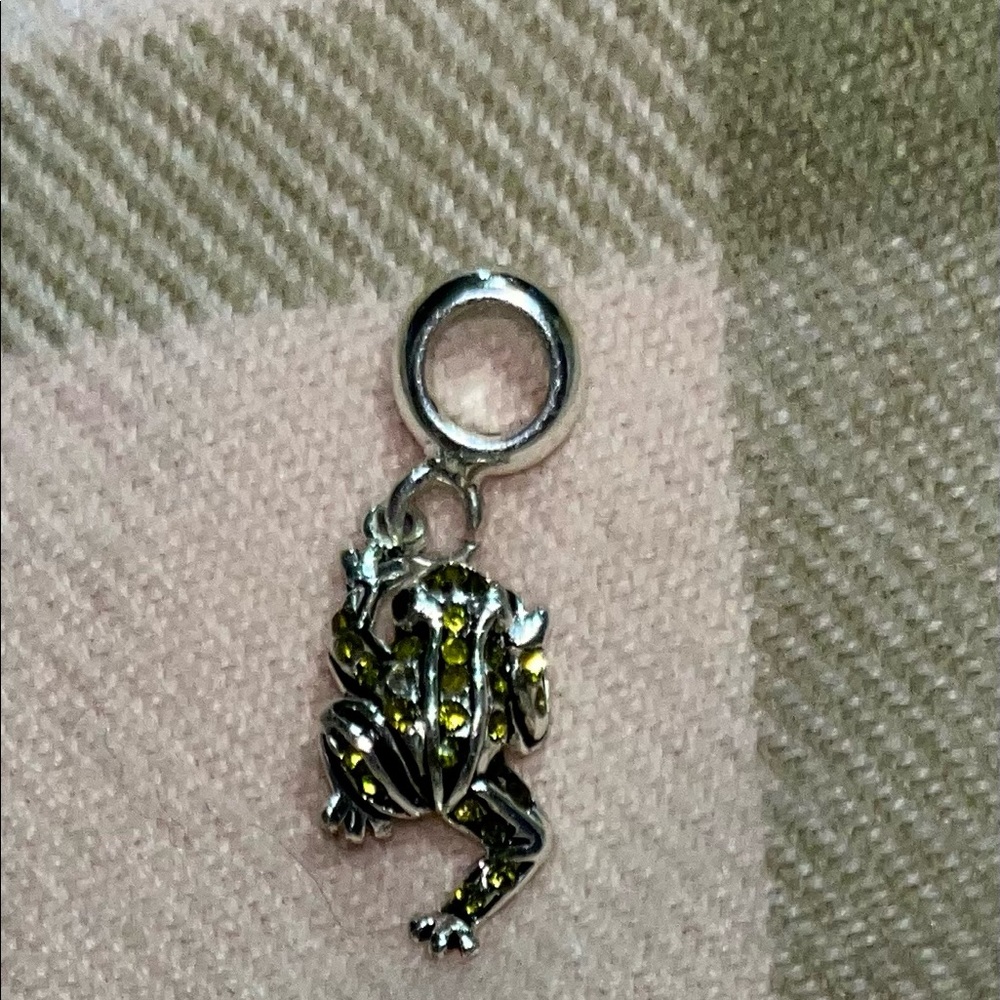 Cute little from charm with yellow crystals.